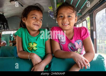 Children riding bus Flores Guatemala Stock Photo