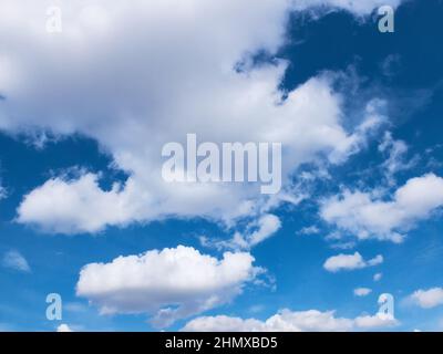 White clouds in a bright blue sky Stock Photo