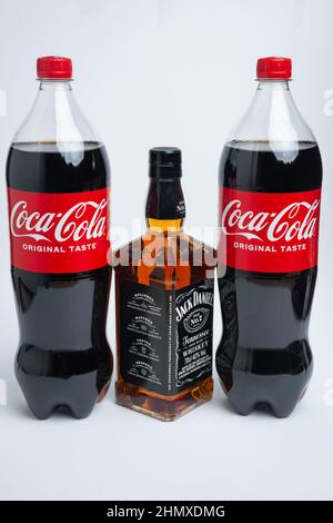 Riga, Latvia February 12.2022:Photo of Coca-Cola plastic bottle and Jack Daniel whiskey Isolated on white Background With clipping path Stock Photo