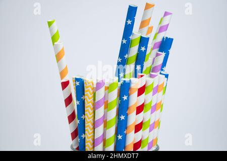 Colorful drinking paper straws for summer cocktails on white background. Copy space. Stock Photo