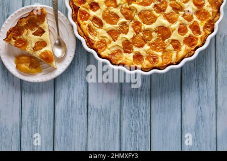 Appetizing cherry plum pie in a baking dish and on a dessert plate Stock Photo