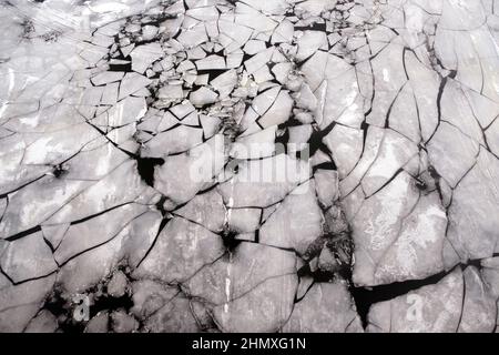 Broken ice floes floating on the river aerial top view from drone Stock Photo