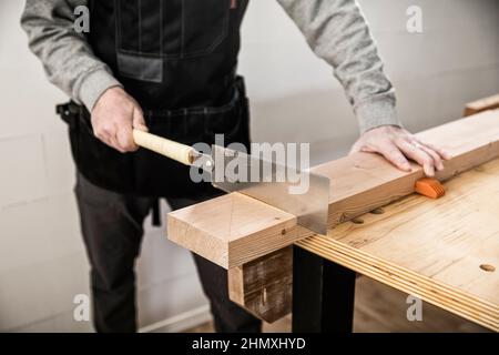 Sawing with a Japanese Ryoba Saw. Stock Photo