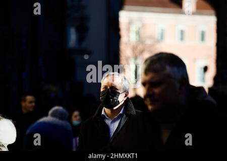 A man wearing a face mask is seen in the Old Town of Warsaw, Poland on 12 February, 2022. Minister of Health Adam Niedzielski this week announced the Stock Photo