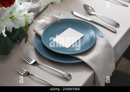 Stylish table setting with blank card Stock Photo