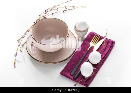 Stylish Easter table setting on white background Stock Photo