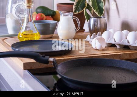 Workplace in kitchen with ingredients and utensils for baking pancakes Stock Photo