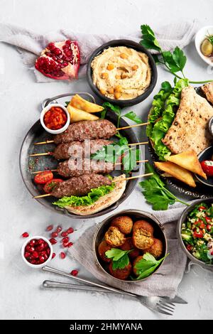 Lebanese food assortment on light background. Traditional food concept. Top view, flat lay, copy space Stock Photo
