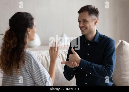 Smiling man and woman with deafness using signs for communication Stock Photo
