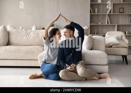 Happy homeowners celebrating relocation, moving into new home Stock Photo