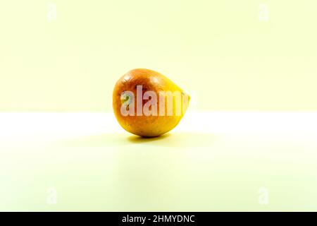 A ripe mango will use your experience with produce such as peaches or avocados, which also become softer as they ripen Stock Photo
