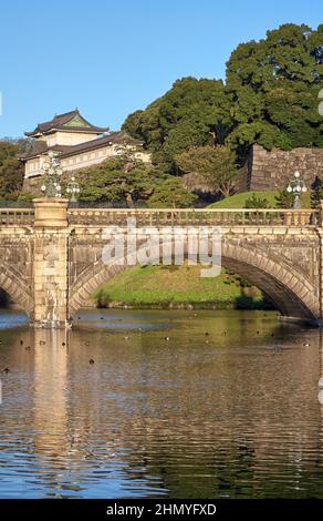 The view of Seimon Ishibashi (a nickname is Meganebashi or Eyeglasses) Bridge over the water of Nijubashi-moat and Fushimi Turret as seen from Kyuden Stock Photo