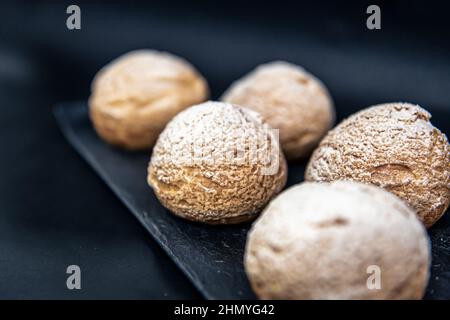 Appetizing Shu cakes on a black background. Stock Photo