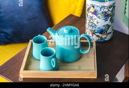 Teapot and two blue cups on the table, top view. Stock Photo