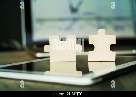 business concept - pieces of puzzles on the modern workplace Stock Photo