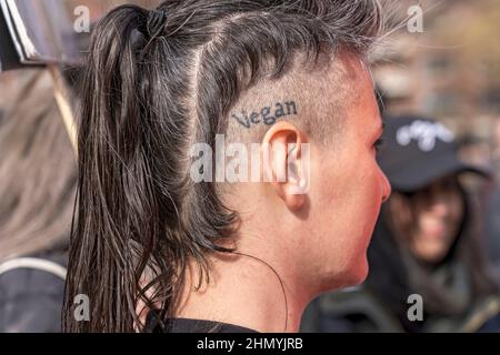 NEW YORK, NY - FEBRUARY 12: Animal Rights activist with a vegan tattoo on her head seen as protesters gather in Washington Square Park for the march on February 12, 2022in New York City.   Animal rights activists holds a peaceful NYC's first Anti-Fur March of the year protesting Dior, Fendi and Louis Vuitton for refusing to go fur free. Credit: Ron Adar/Alamy Live News Stock Photo