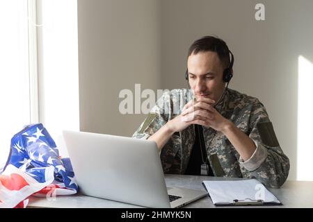 Soldier working with laptop in headquarters building Stock Photo
