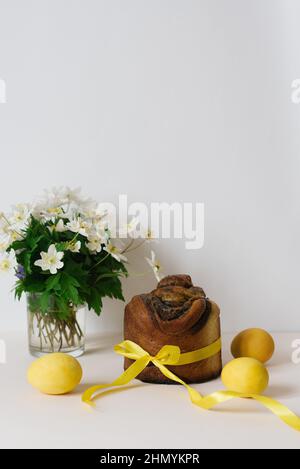 Easter composition with orthodox sweet bread, kulich and eggs on beige background. Easter holidays breakfast concept. Stock Photo