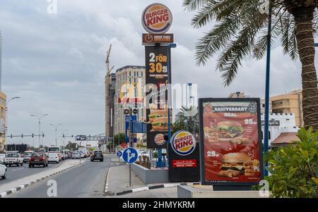 Doha, Qatar - January 16th 2022: Fast food outlets advertising along the c ring road in Doha, Qatar Stock Photo