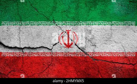 Full frame photo of a weathered flag of Iran painted on a cracked wall. Stock Photo