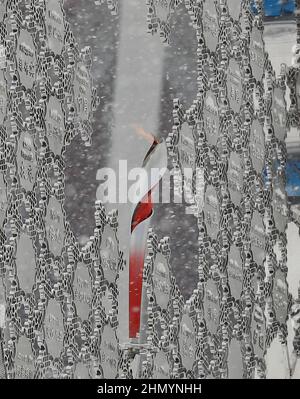 Beijing, Hebei, China. 13th Feb, 2022. Snow falls around the Olympic Flame in the Beijing Medals plaza in the Beijing 2022 Olympic Winter Games. (Credit Image: © David G. McIntyre/ZUMA Press Wire) Credit: ZUMA Press, Inc./Alamy Live News Stock Photo