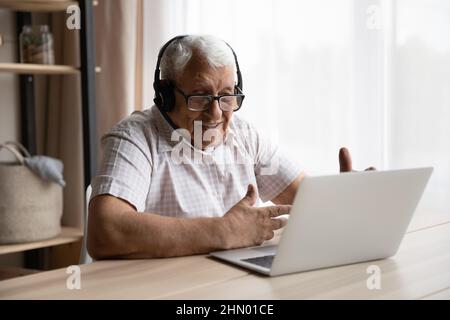 Happy older 80s man talking to family on video call Stock Photo