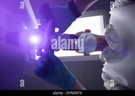 Dentist makes an operation using a dental microscope  Stock Photo