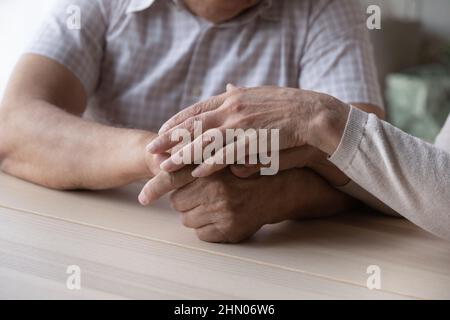 Elderly couple holding hands with love and support close up Stock Photo