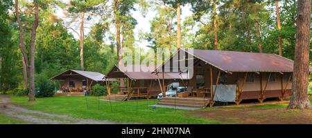 Glamping at a campsite. Luxury tent lodges with all kinds of services for glamorous stay outdoors Stock Photo