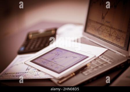 Closeup picture of a keyboard with a phone and tablet lying above it Stock Photo
