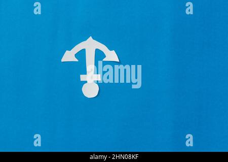 White Anchor on Isolated Blue background. Nautical theme. Copy Space. Stock Photo