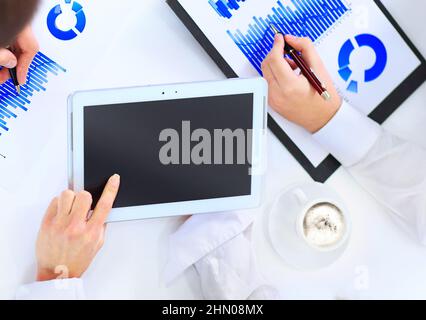 Close-up of business team hands over papers during discussion of a new project Stock Photo