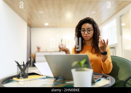 Black woman having video call using laptop and talking Stock Photo