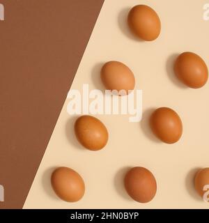 Ogranic eggs for Easter on bright pastel beige and brown background. Flat lay minimal pattern Stock Photo