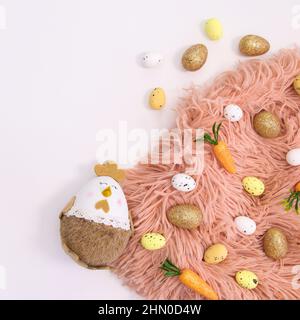 Easter arrangement on white background with pastel pink fur and egaster eggs and decorations. Flat lay Stock Photo