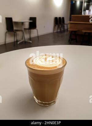 Piccolo Latte, an espresso shot topped with smooth, steamed milk; served in a small 3-4 oz glass. Tasty coffee with latte art. Stock Photo