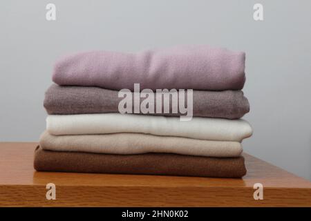 Pile or stack of colorful, folded cashmere or merino wool jumpers. Stock Photo