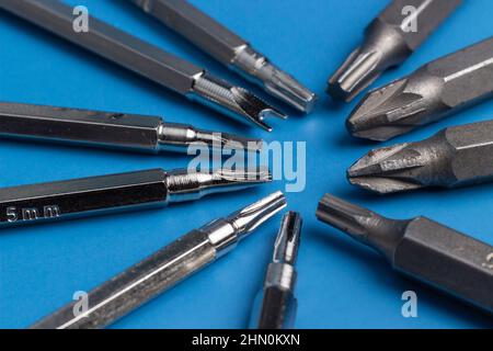 A set of long bits for a screwdriver. Different form, Ten Variations. Blue background. Stock Photo