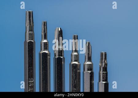 A set of long bits for a screwdriver. Different form, Six Variations. Blue background. Stock Photo