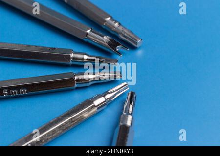 A set of long bits for a screwdriver. Different form, Six Variations. Blue background. Stock Photo