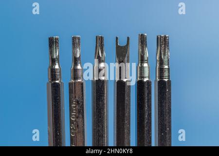 A set of long bits for a screwdriver. Different form, Six Variations. Blue background. Stock Photo
