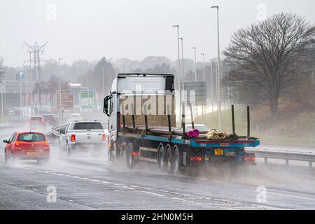 Dundee, Tayside, Scotland, UK. 13th February 2022. UK Weather: North East Scotland is experiencing light winds and torrential downpours with temperatures reaching 7°C. Sunday drivers on the busy Dundee Kingsway West dual carriageway face hazardous and wet conditions. Credit: Dundee Photographics/Alamy Live News Stock Photo