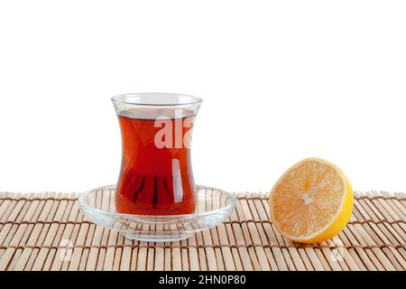 Glass of turkish tea and lemon on white background Stock Photo