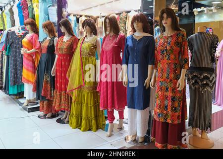 Mannequins dressed in trendy national Central and South Asia fashion casual clothes displayed in front of retail shop Stock Photo