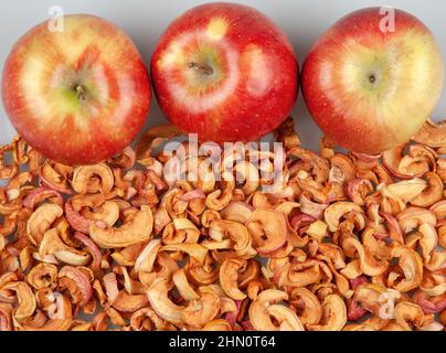 Fresh red apples on dried apple slices Stock Photo