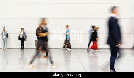 Many anonymous business people go to the trade fair Stock Photo