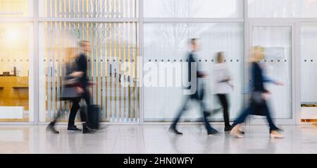 Anonymous blurred group of business people go on gear in the office Stock Photo