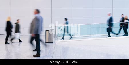 Many anonymous business people go aisle in the office Stock Photo