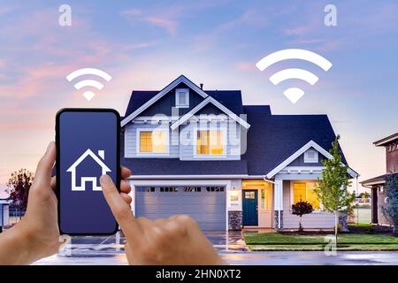 Home wifi automation. Internet of things. A woman controls her smart home with an App on her smartphone. IoT concept. Stock Photo