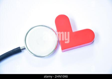 red heart and stethoscope medical equipment for doctor listening pulse of patient on white background Stock Photo